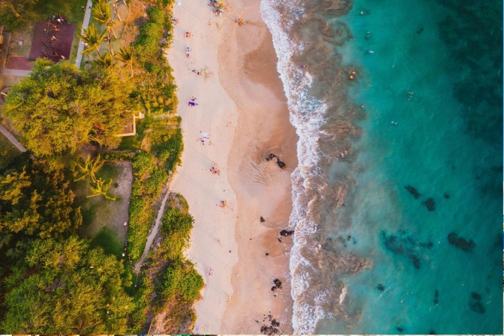 Hawaii Waikiki Beach at sunset with couples enjoying the golden hour oceanfront