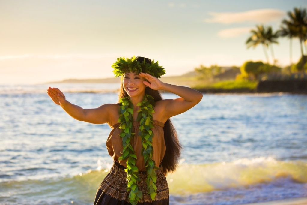 Person in traditional attire by ocean.