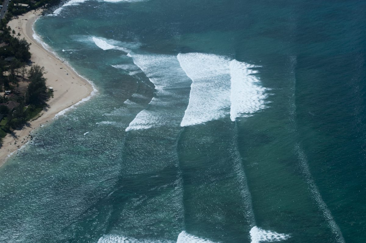 Aerial view of surf breaks along the North Shore coastline near Turtle Bay, Oahu